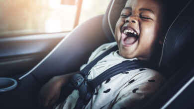happy african american kid in a car seat