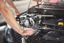 close up hands of unrecognizable mechanic doing car service and maintenance