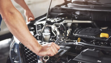 close up hands of unrecognizable mechanic doing car service and maintenance