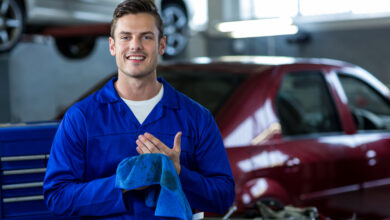 portrait of mechanic wiping hands with cleaning cloth