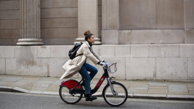young woman riding a bike in the city
